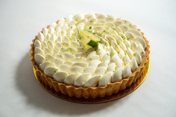 Lime Tart with whipped cream and lime slices