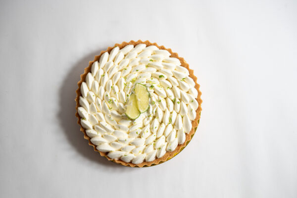 Lime Tart with whipped cream and lime slices