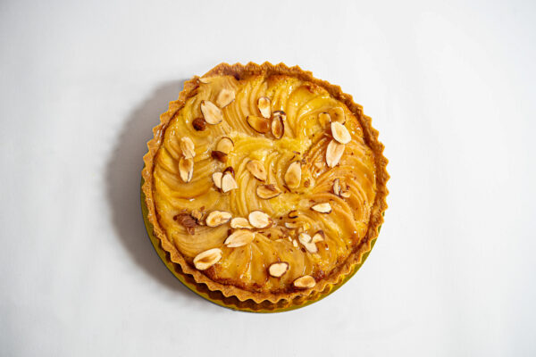 Pear Almond Tart with cut almonds and glazed apples